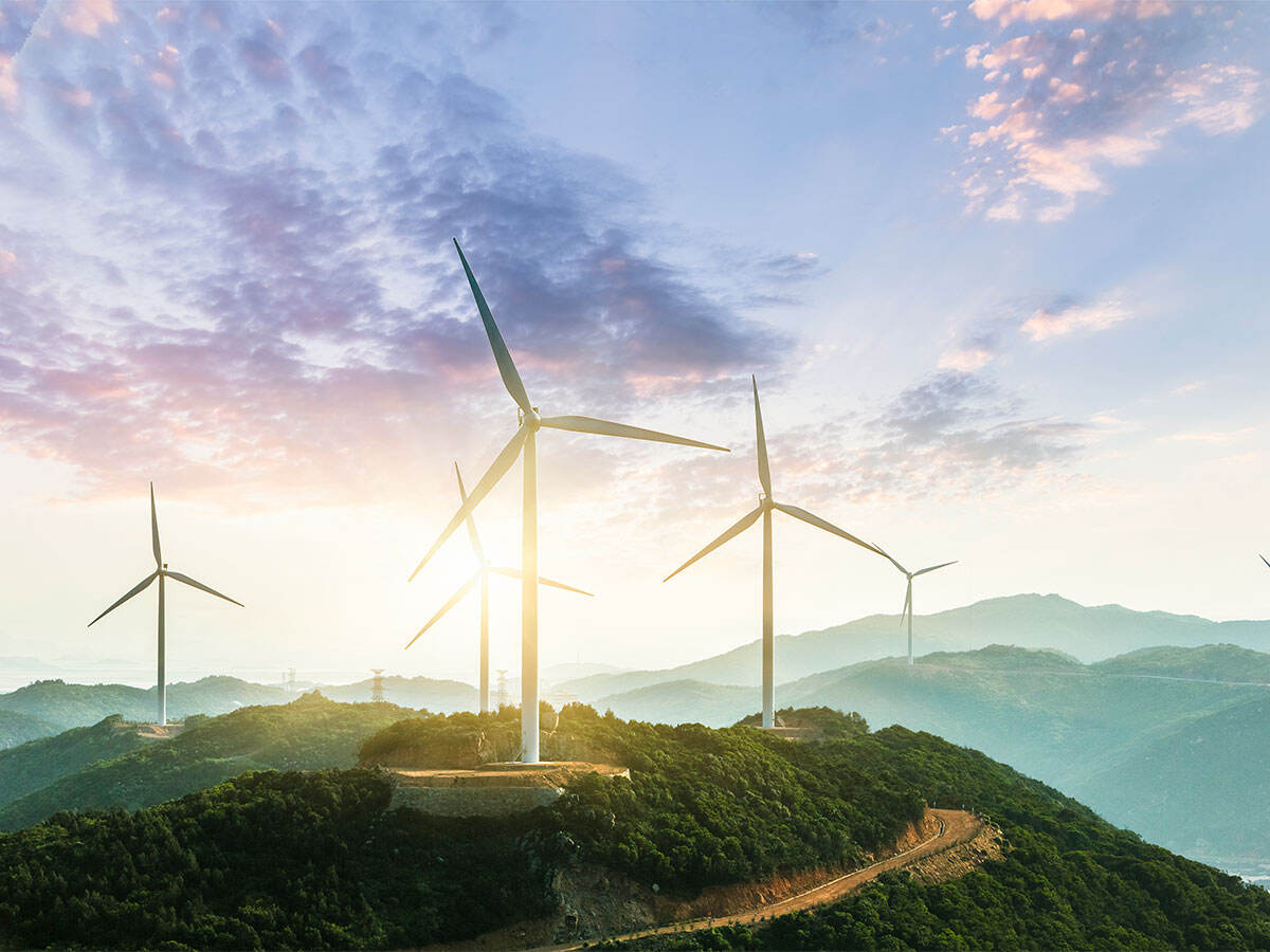 windmills on a hill in an opalescent sunrise