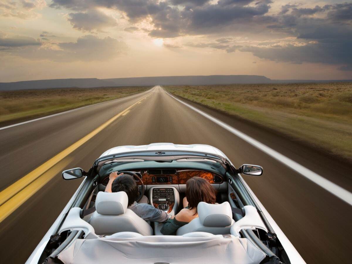 A white convertible on a highway