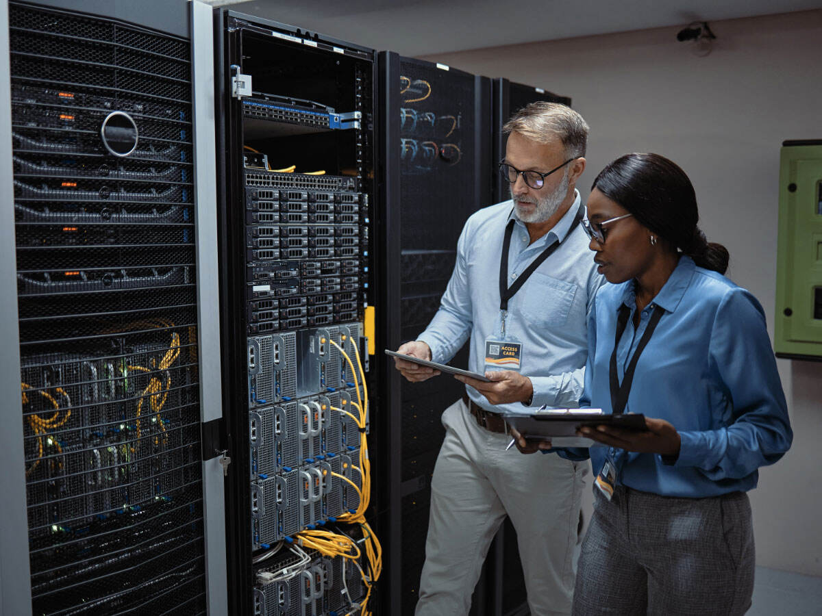 IT technicians fixing a computer system and network while doing maintenance in a datacenter