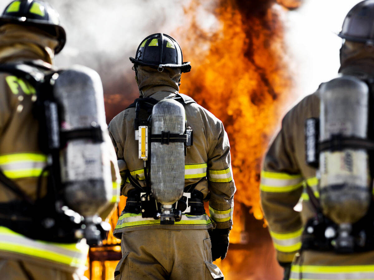 Three firefighters putting out an house fire