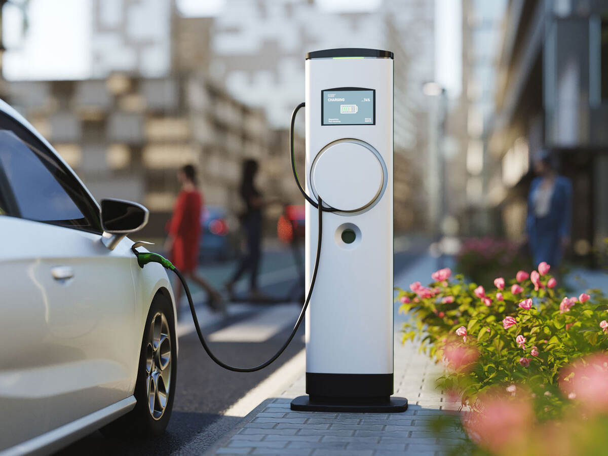 An electric vehicle charging at a charging station