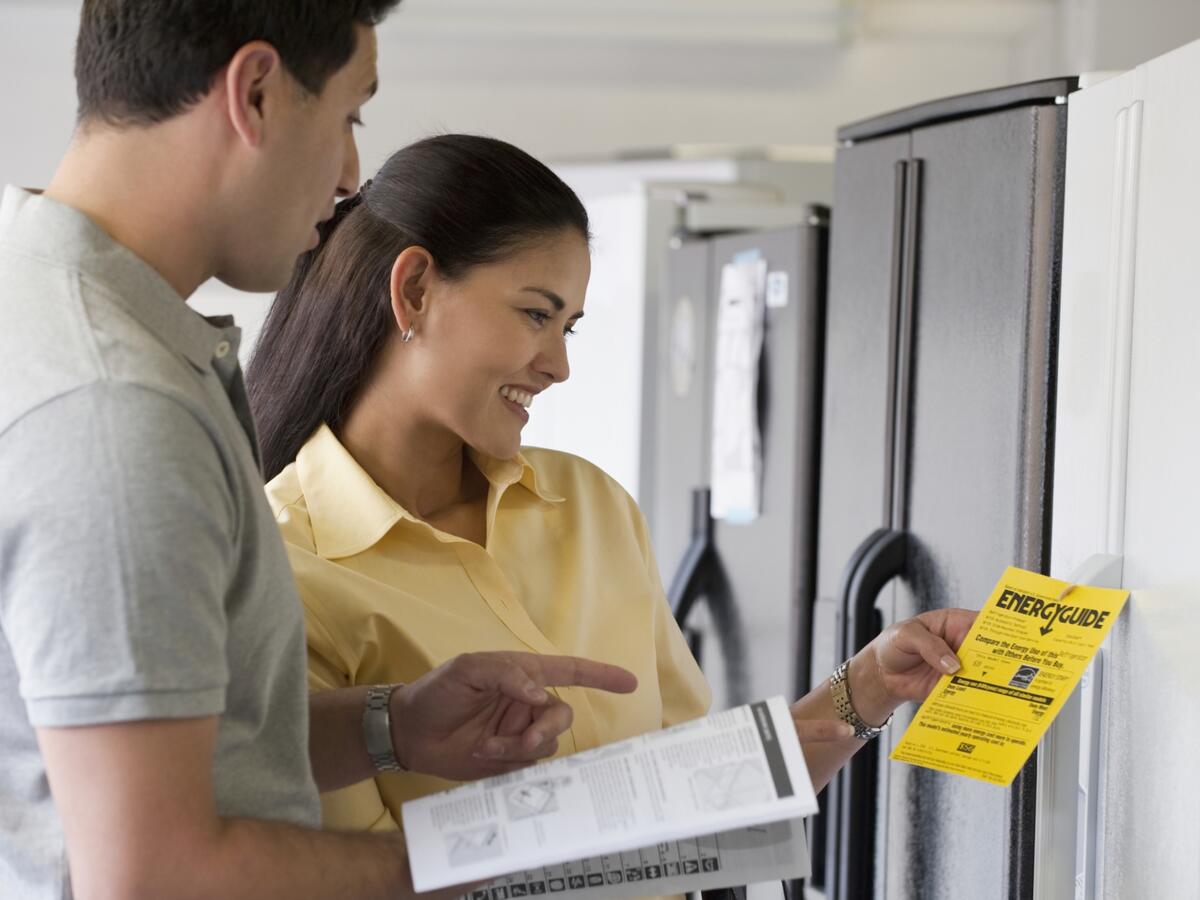 Couple shopping for refrigerator