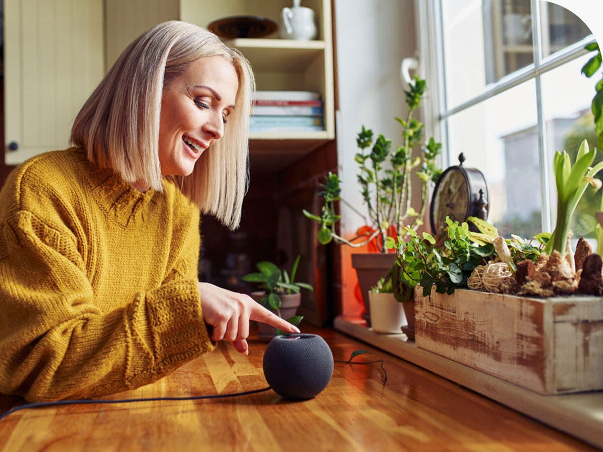Person using a smart speaker in a kitchen