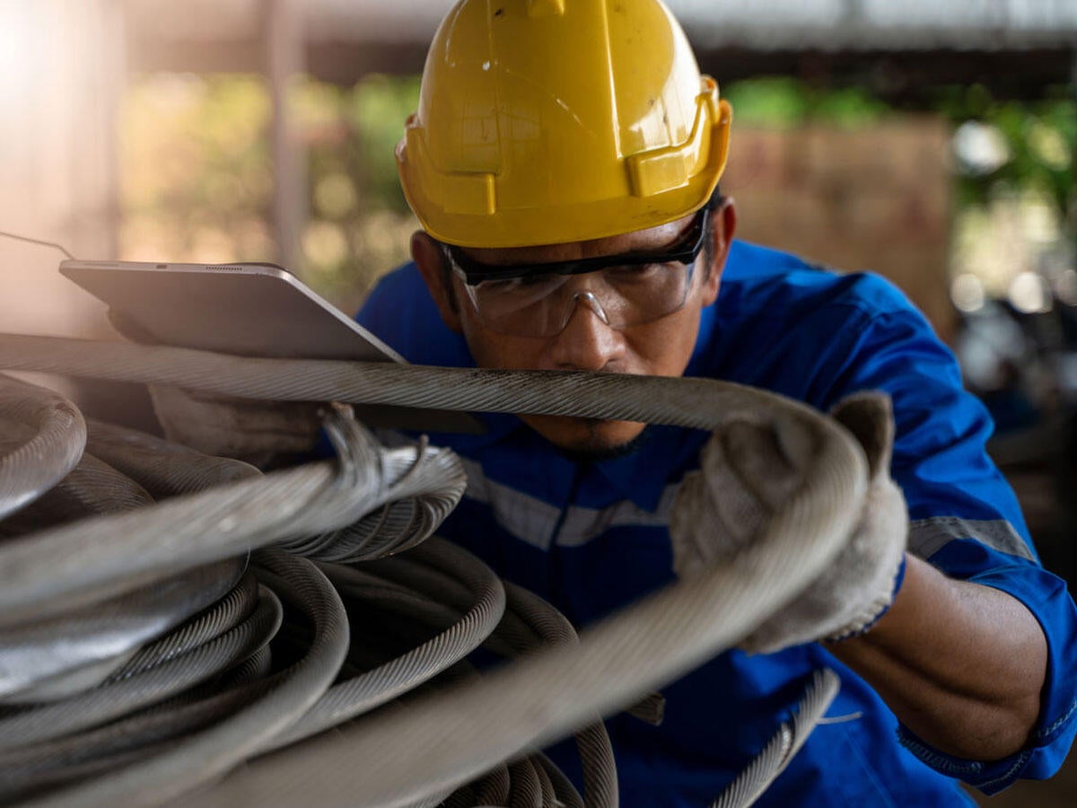 Engineer inspecting a wire cable