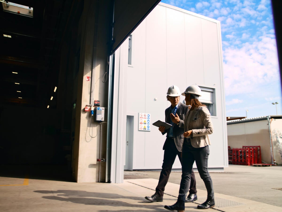 Two managers walking into a factory