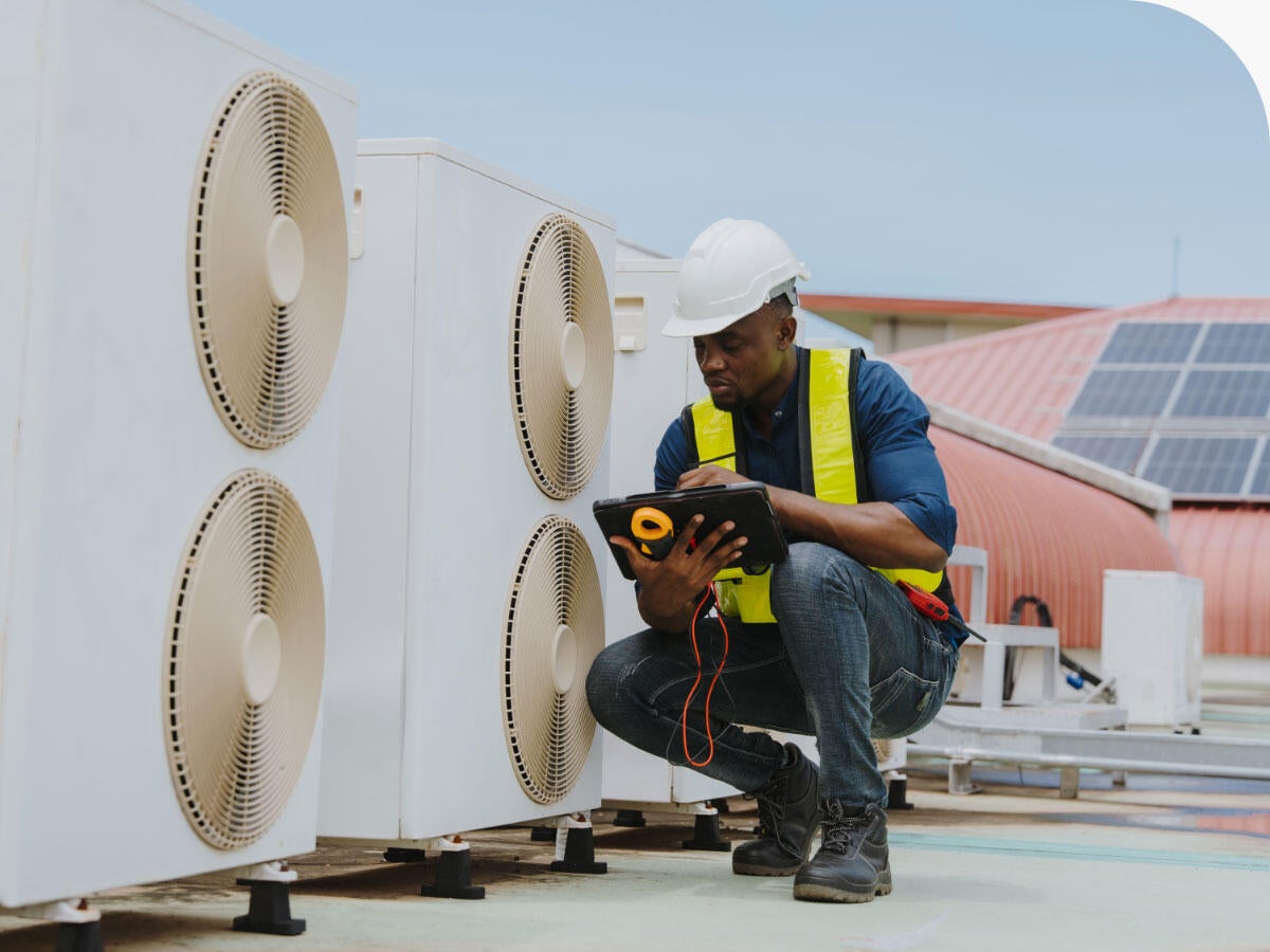 Engineer checking the air conditioning and cooling system in a commercial building.