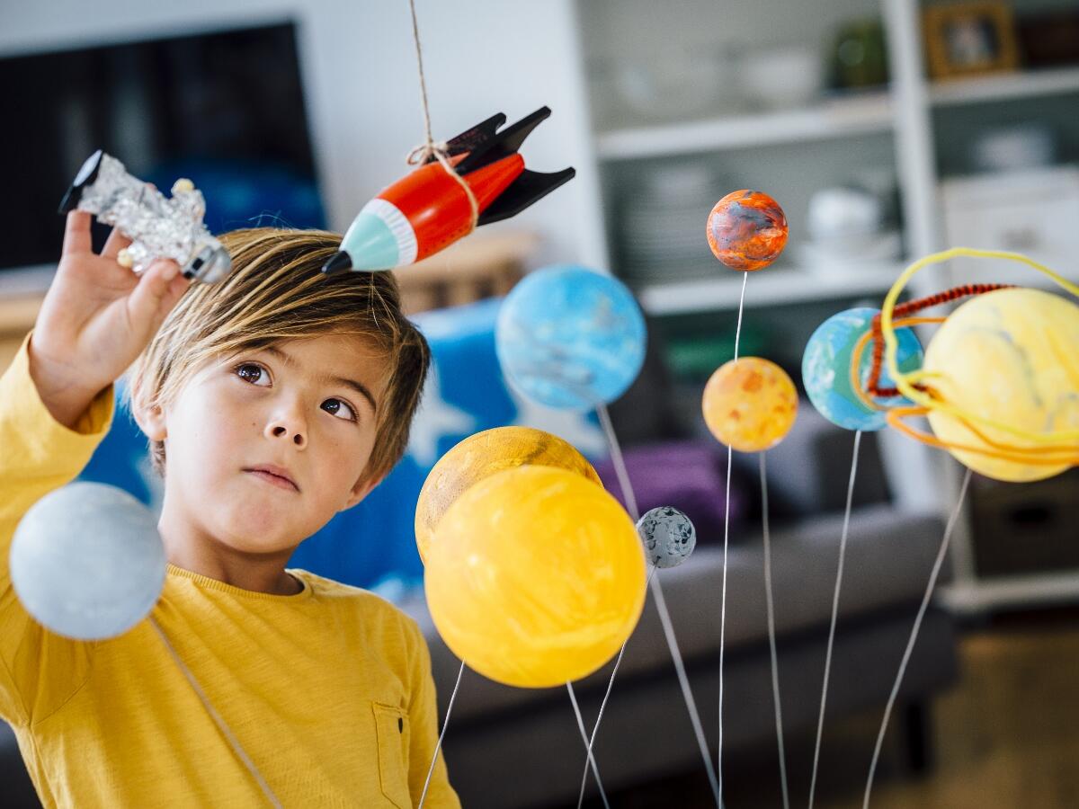 A child playing with a constellation toy