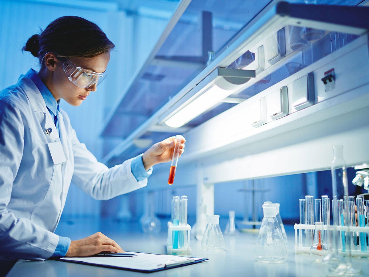 A scientist examining a liquid in a test tube