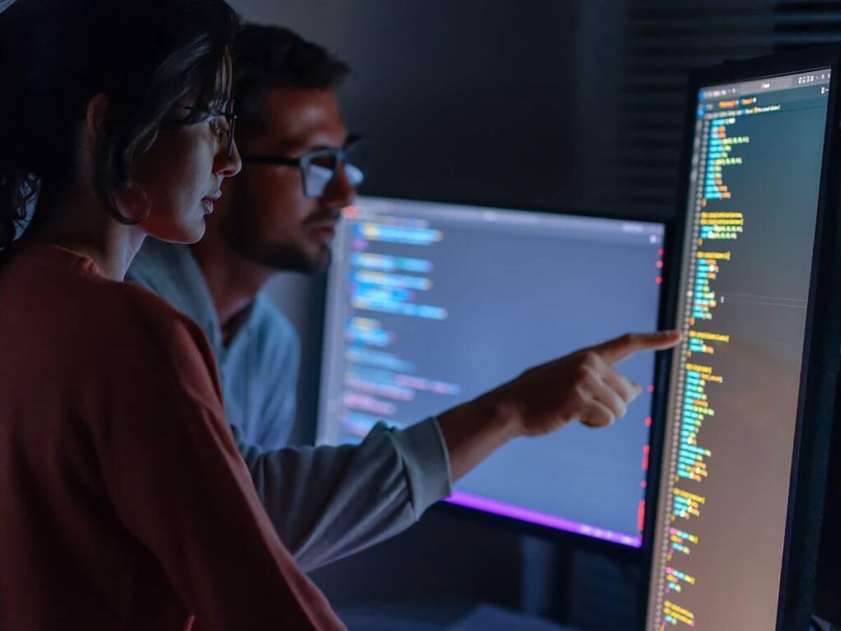 Two people looking at a monitor