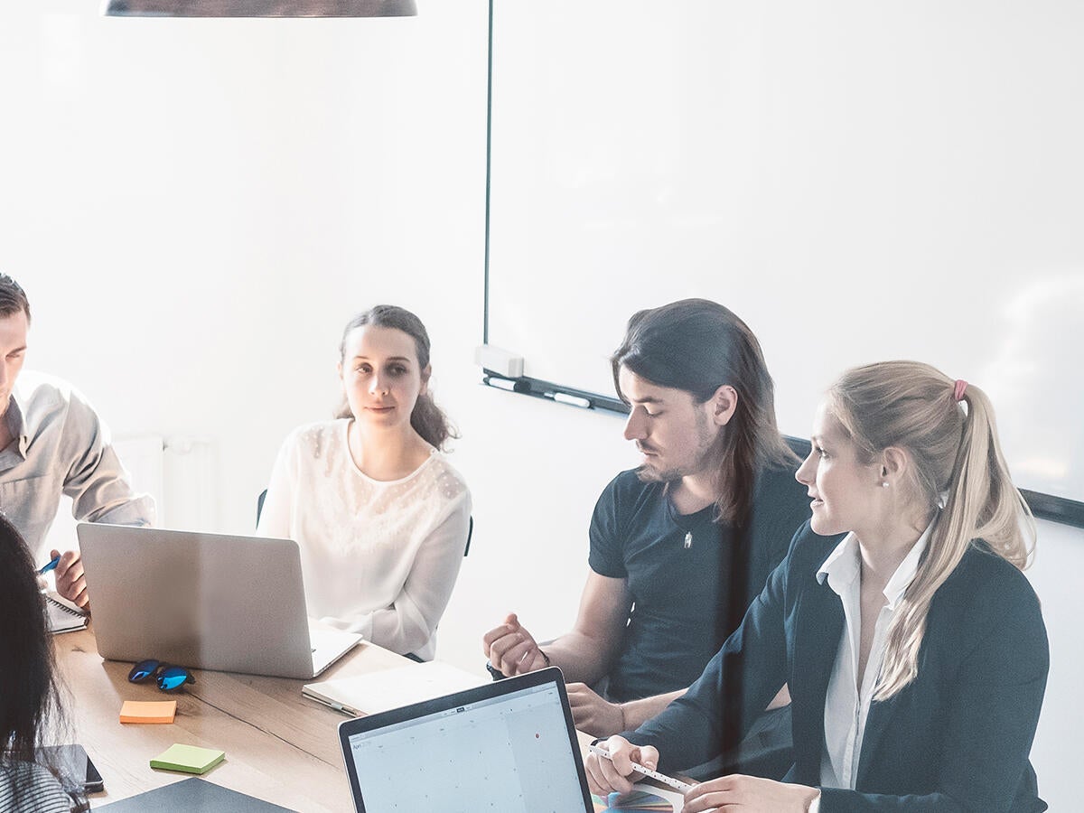 A group of people around a conference table