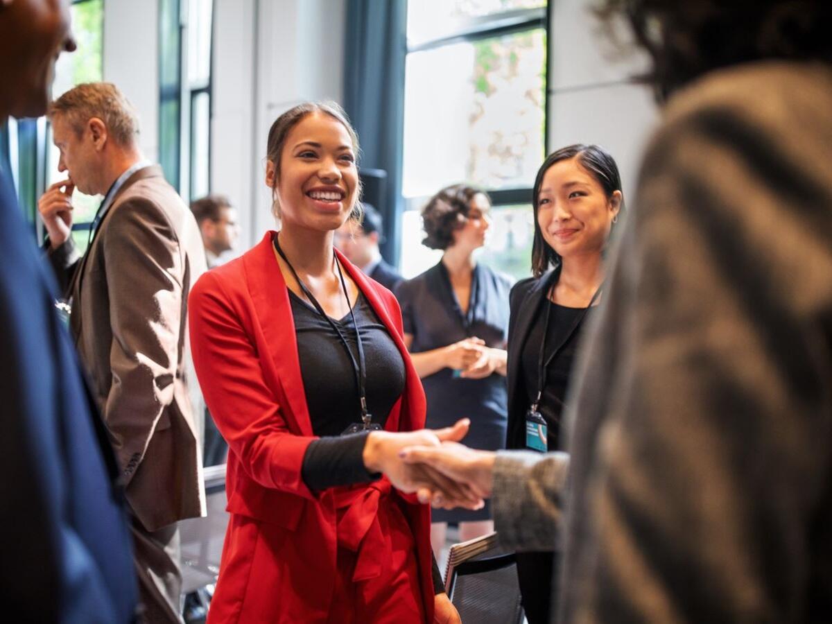 people shaking hands at event