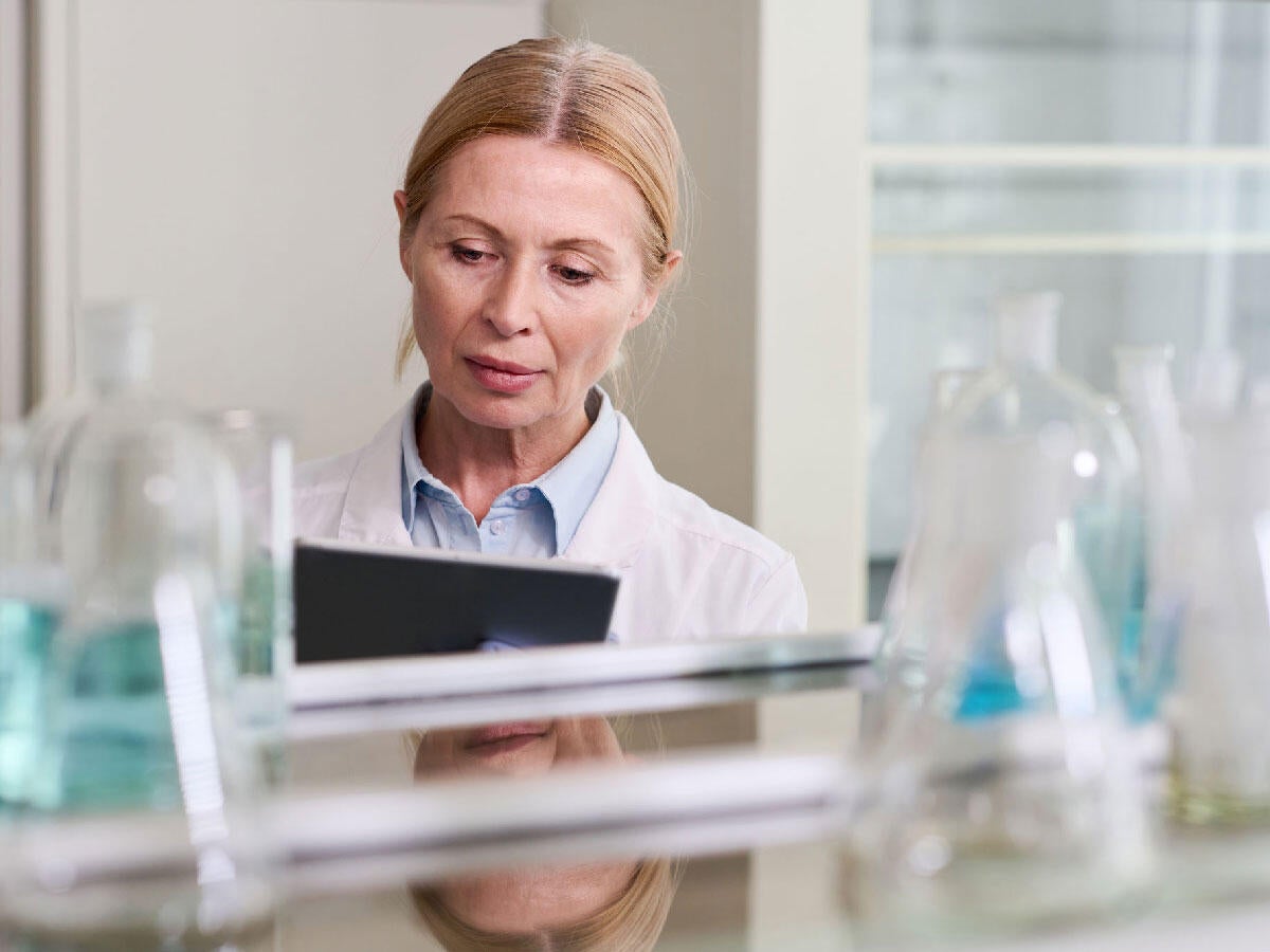 A doctor working on a tablet in a laboratory setting