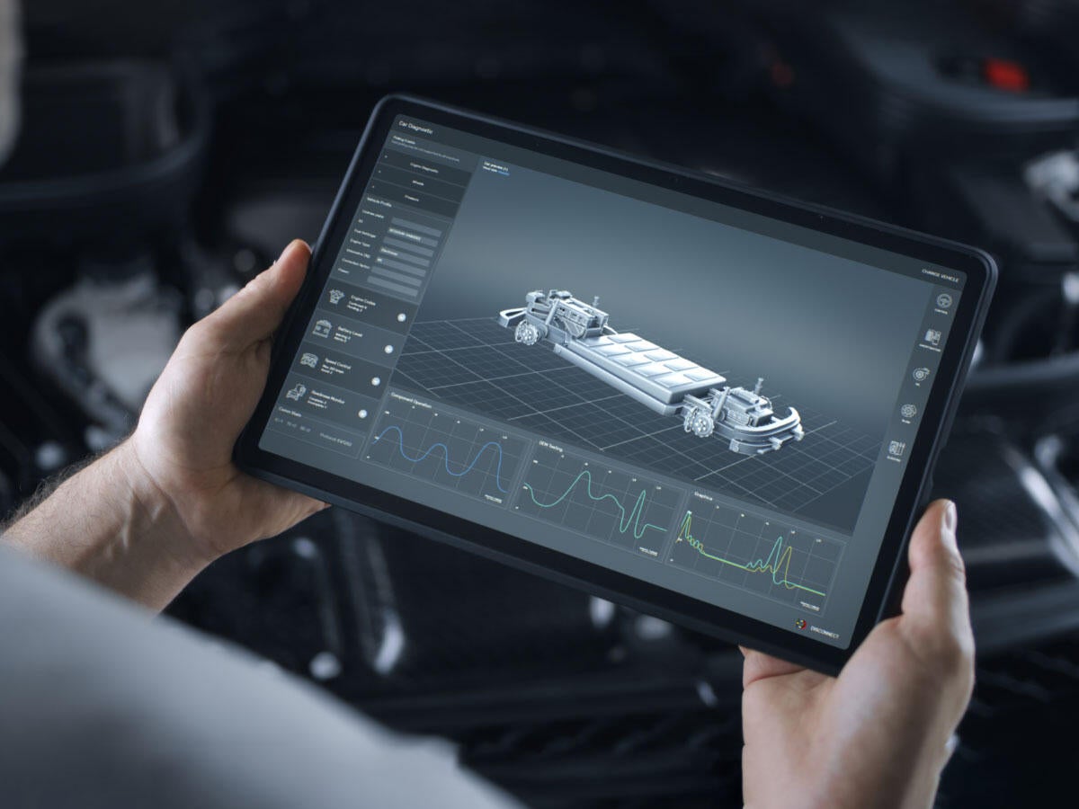 A person looking at an EV battery on a tablet