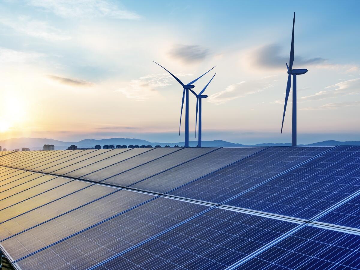 windmills and solar panels in a beautiful sunrise
