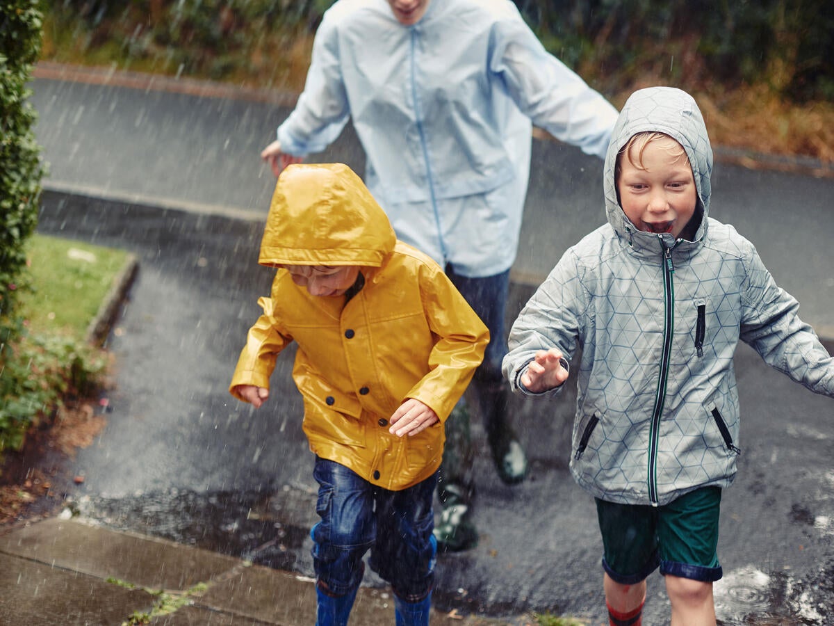 A family running in the rain
