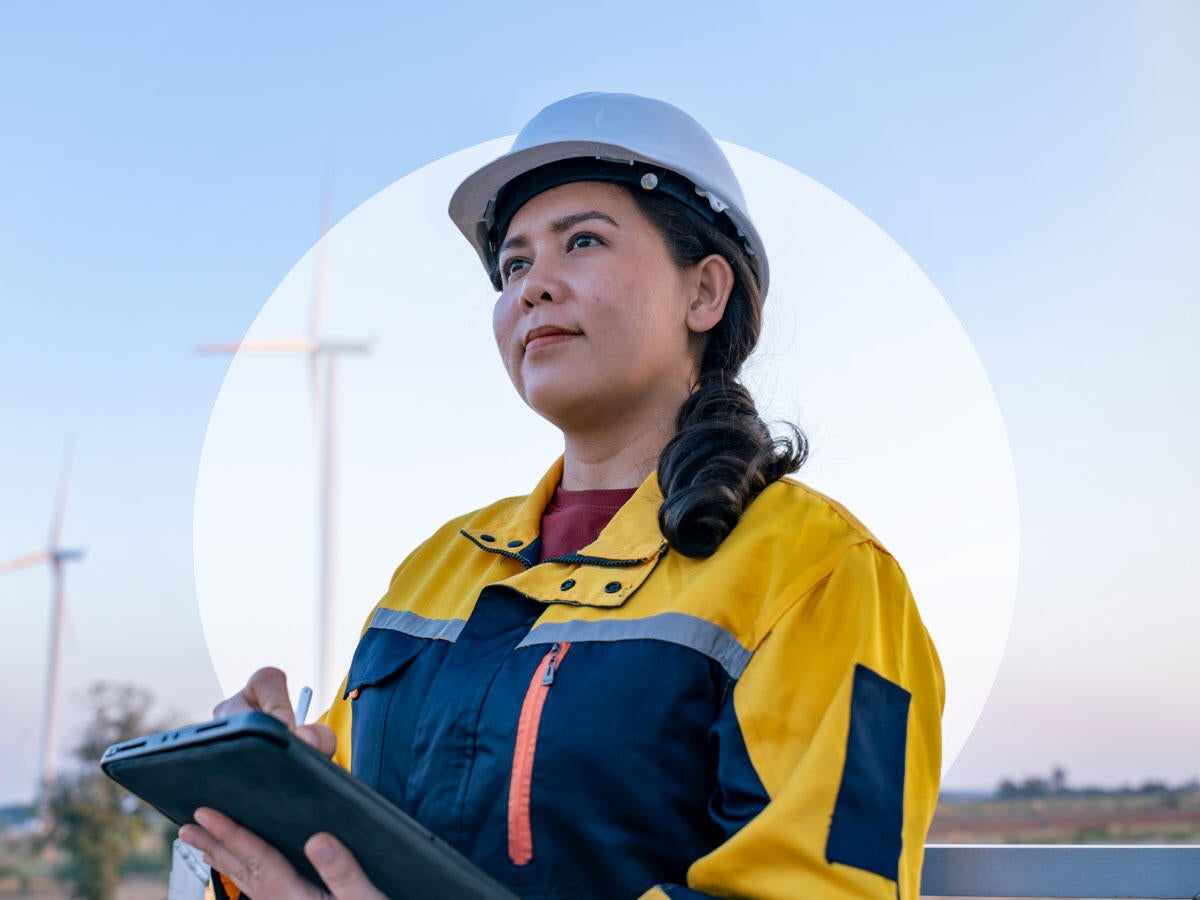 A person in a hard hat, looking to the future