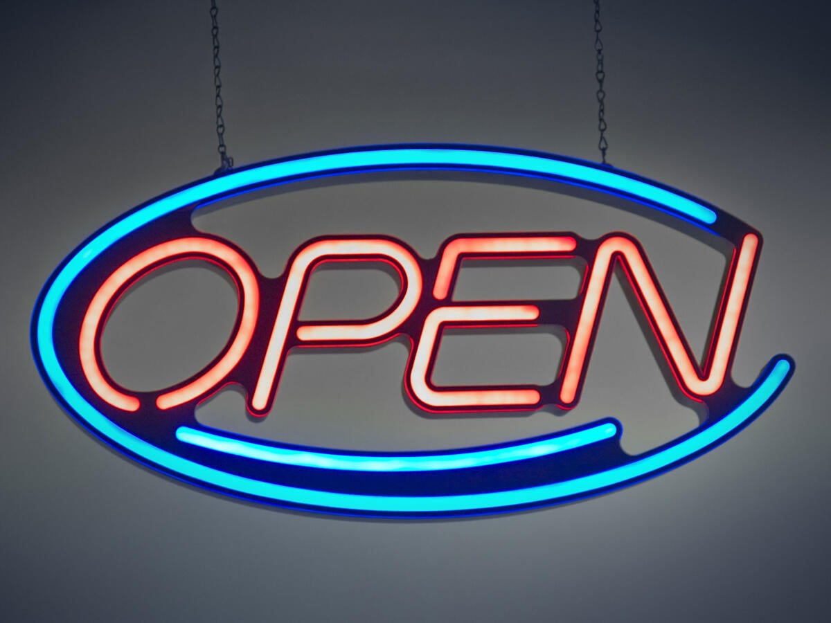 A neon sign that says open