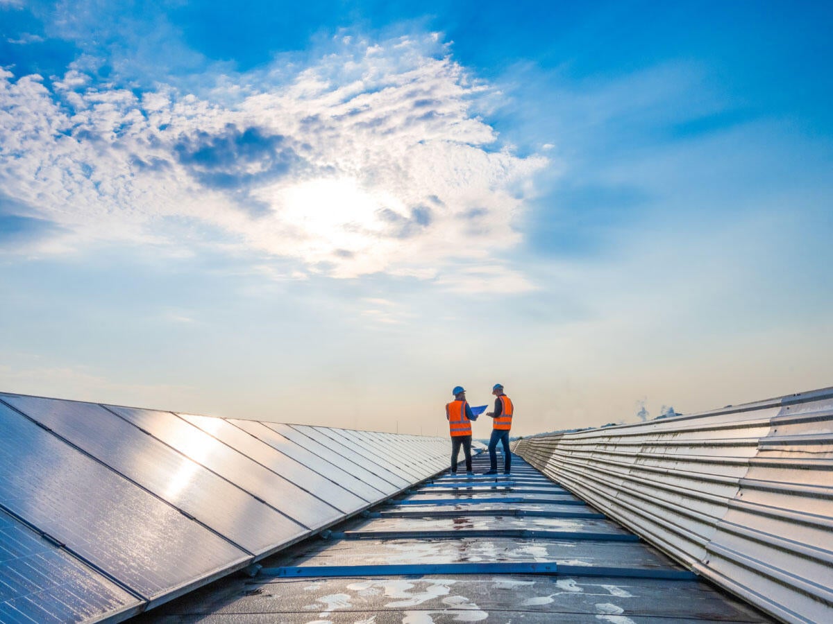 Two engineers inspecting solar panels