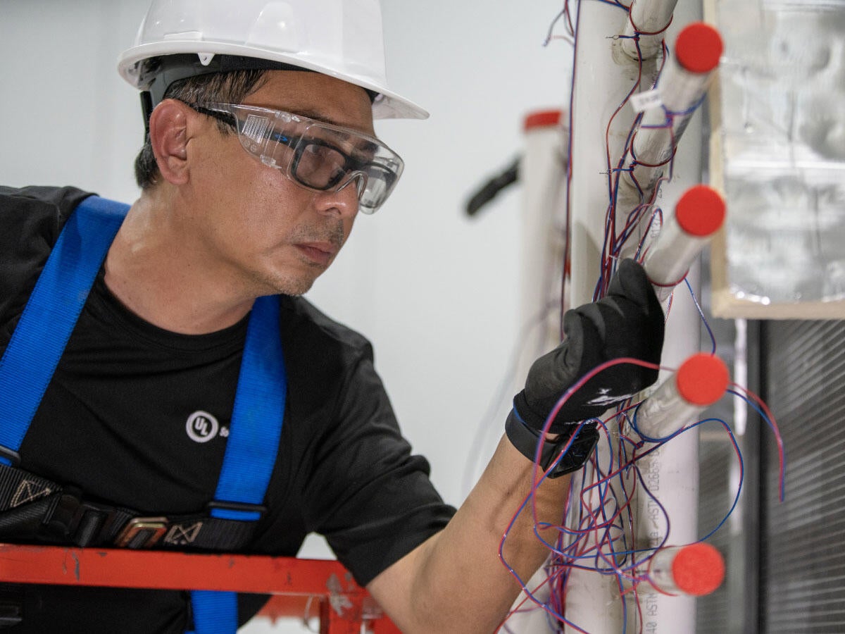A tester working at the Plano HVAC laboratory