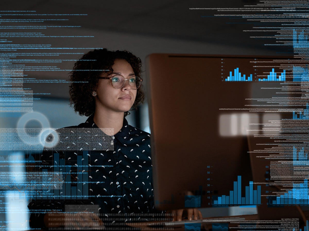 A person reviewing charts on a large monitor