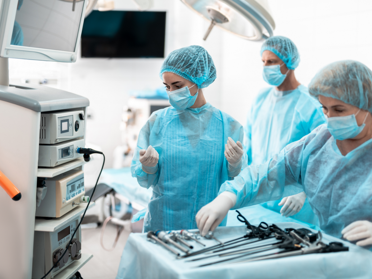 Three medical workers in a surgical suite