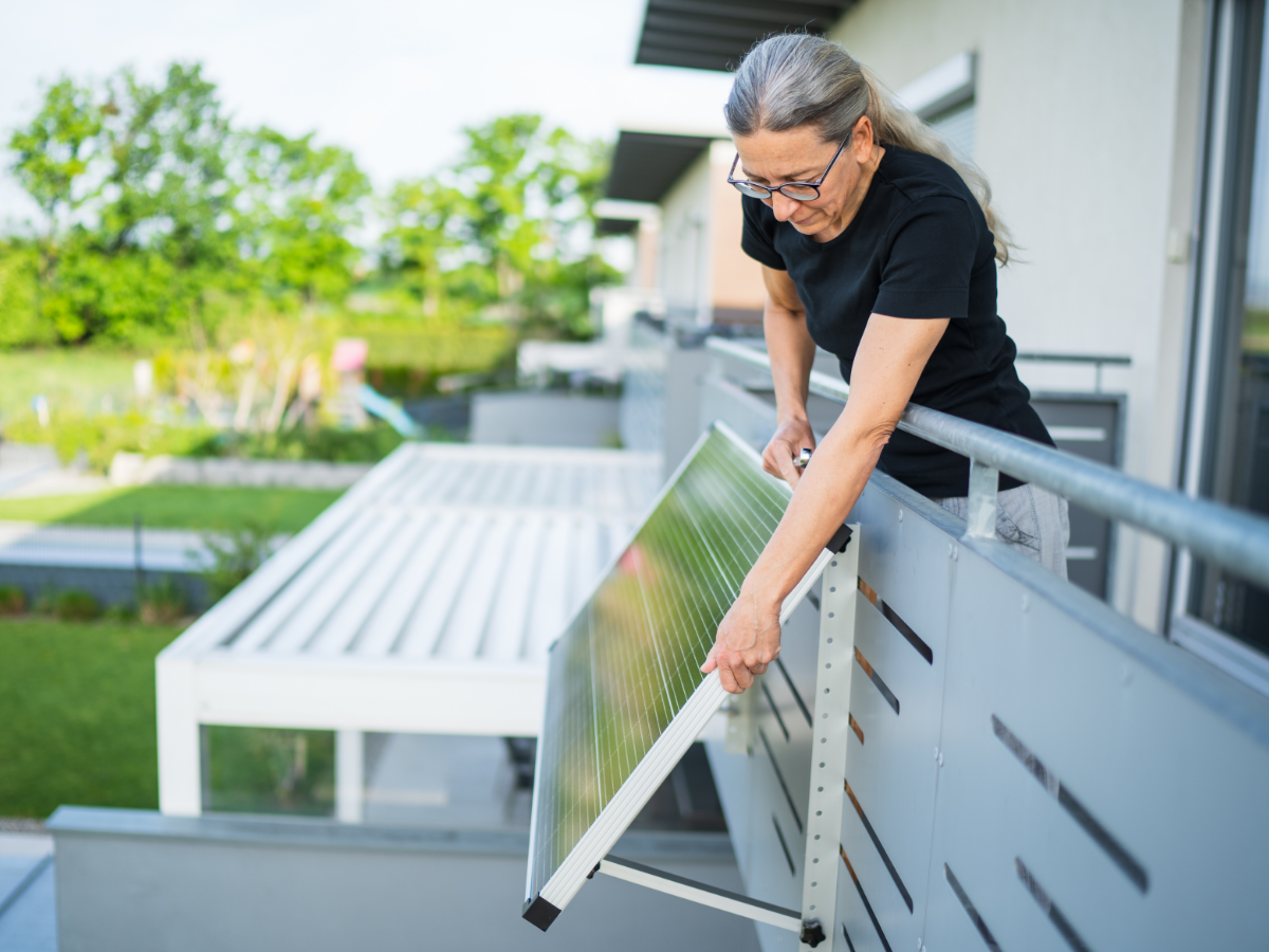 Woman adjusting solar panel