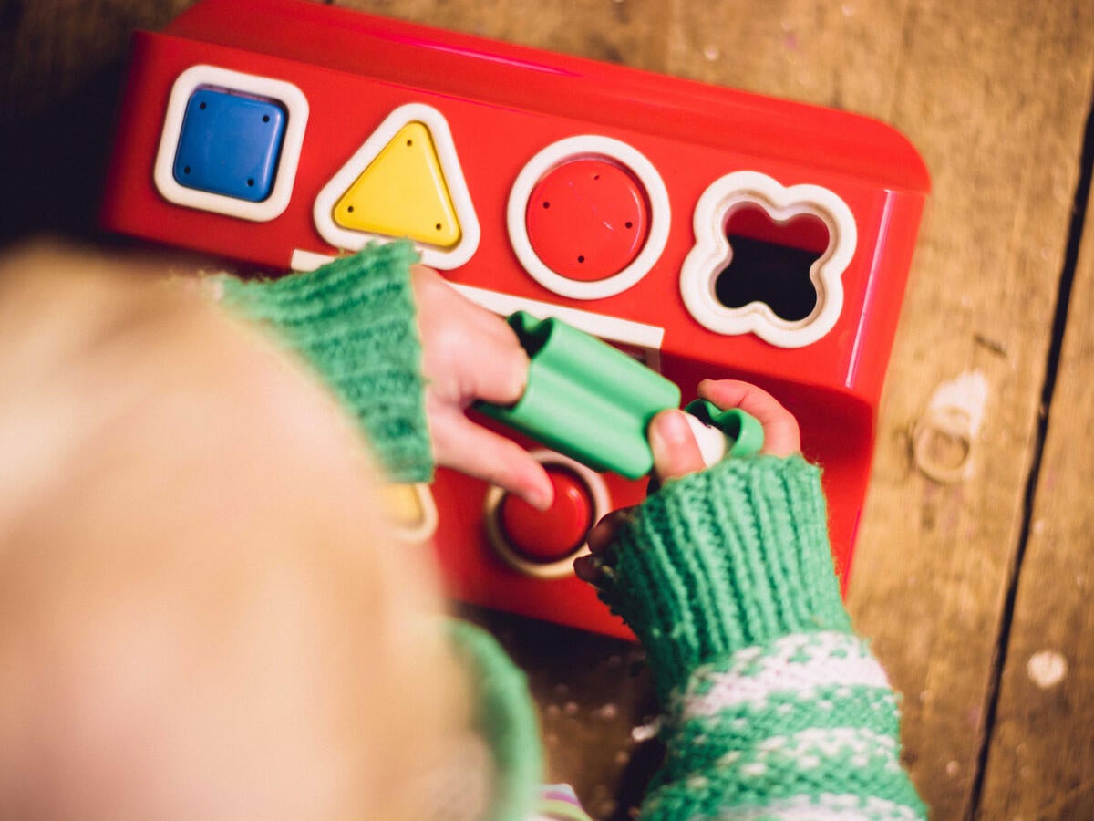 A child playing with a shape board