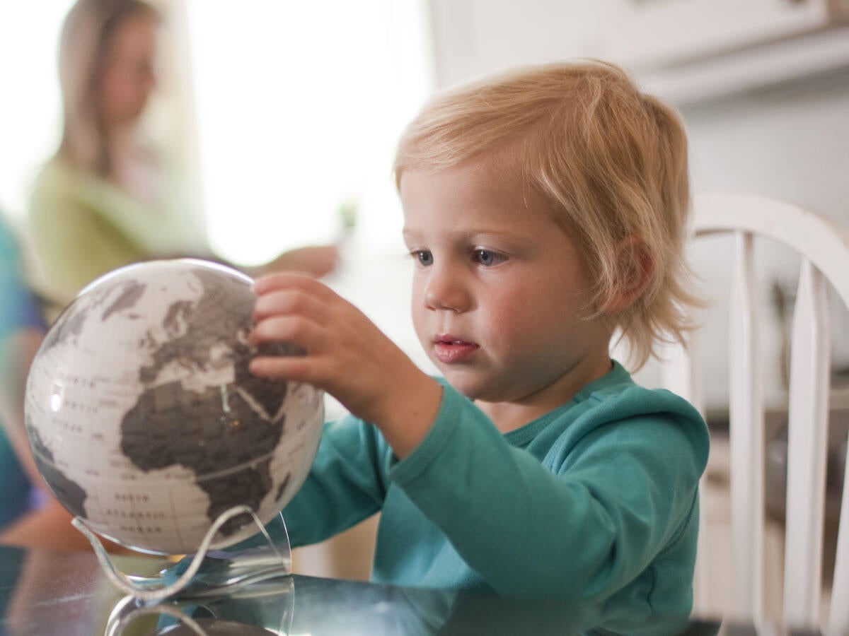 A child looking at a globe