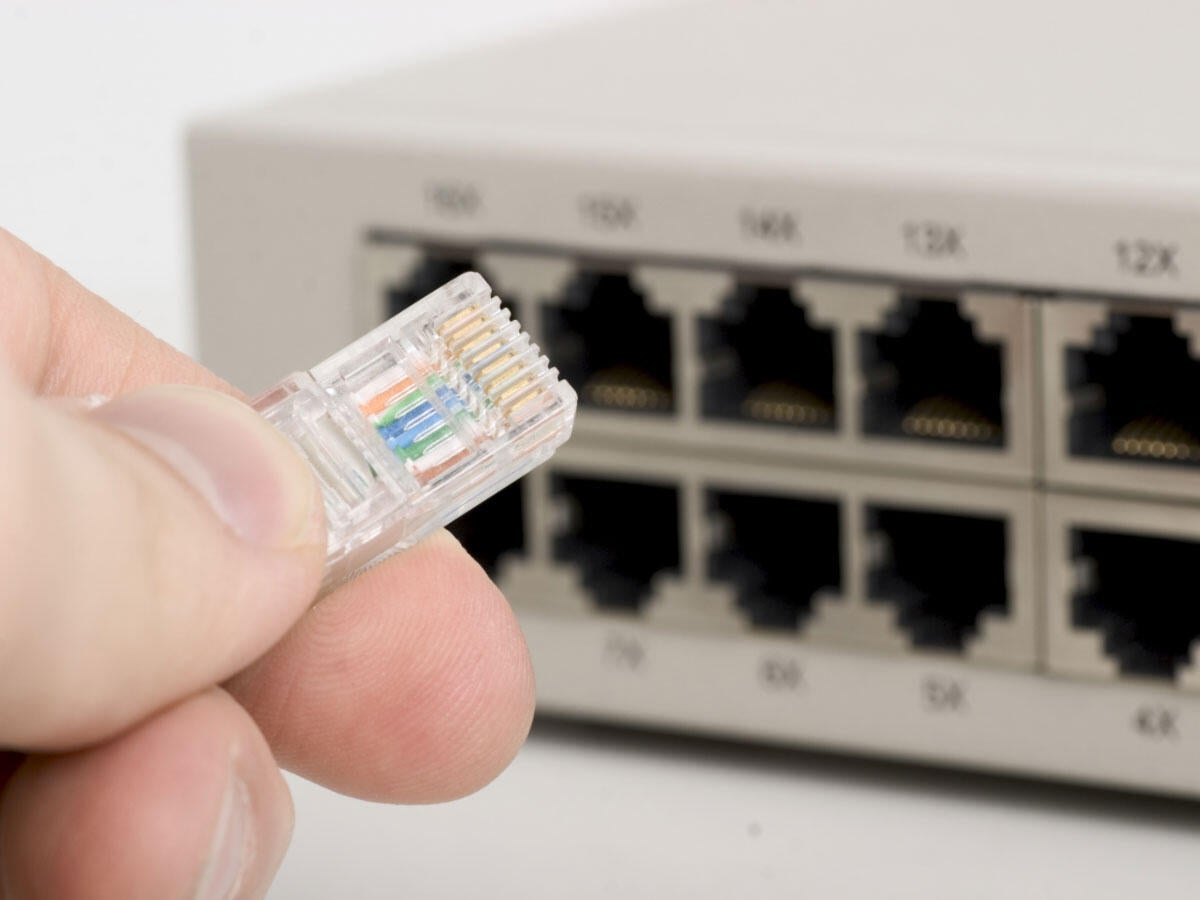 Person plugging an ethernet cable
