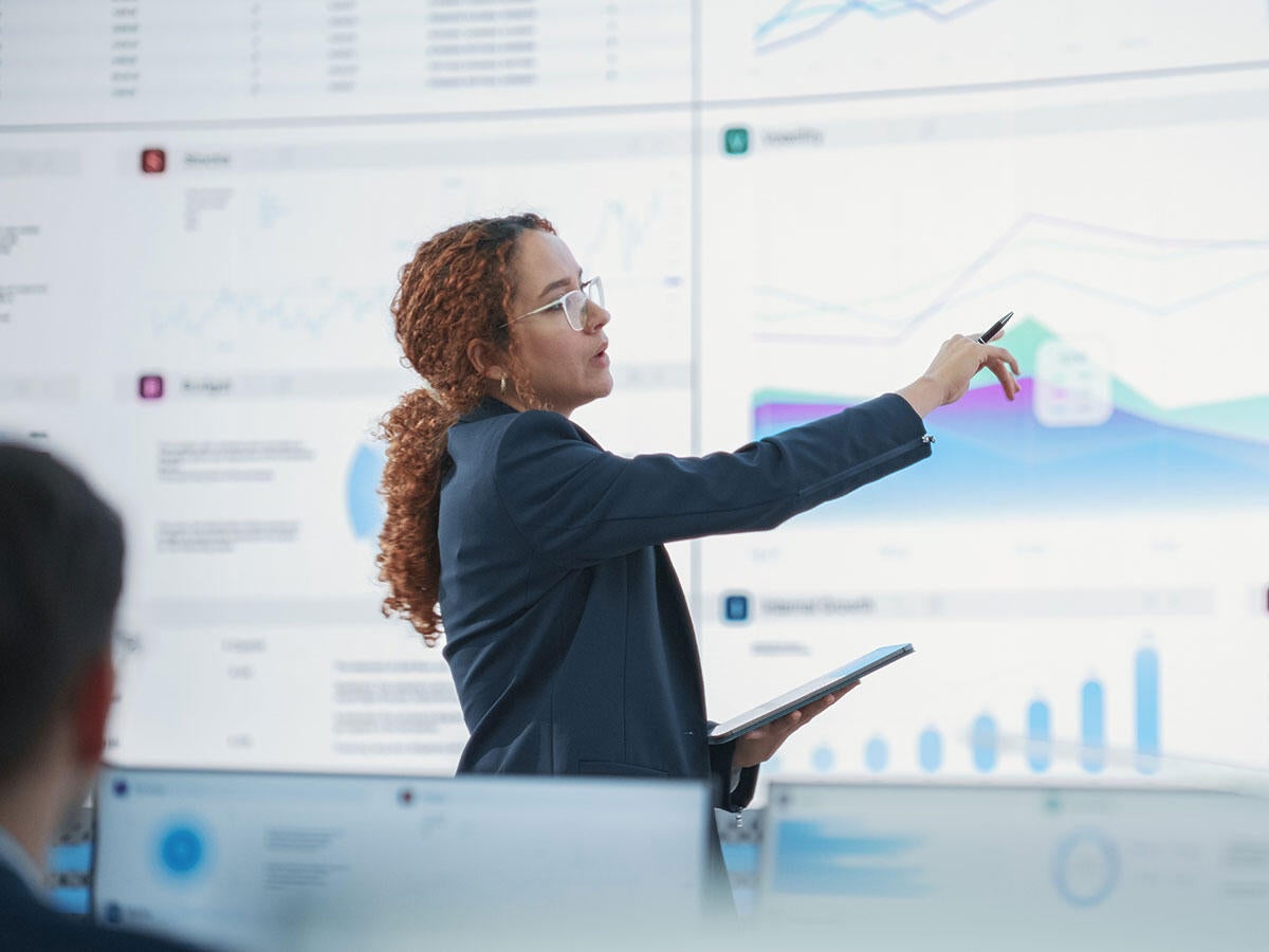 A person reviewing report on a whiteboard
