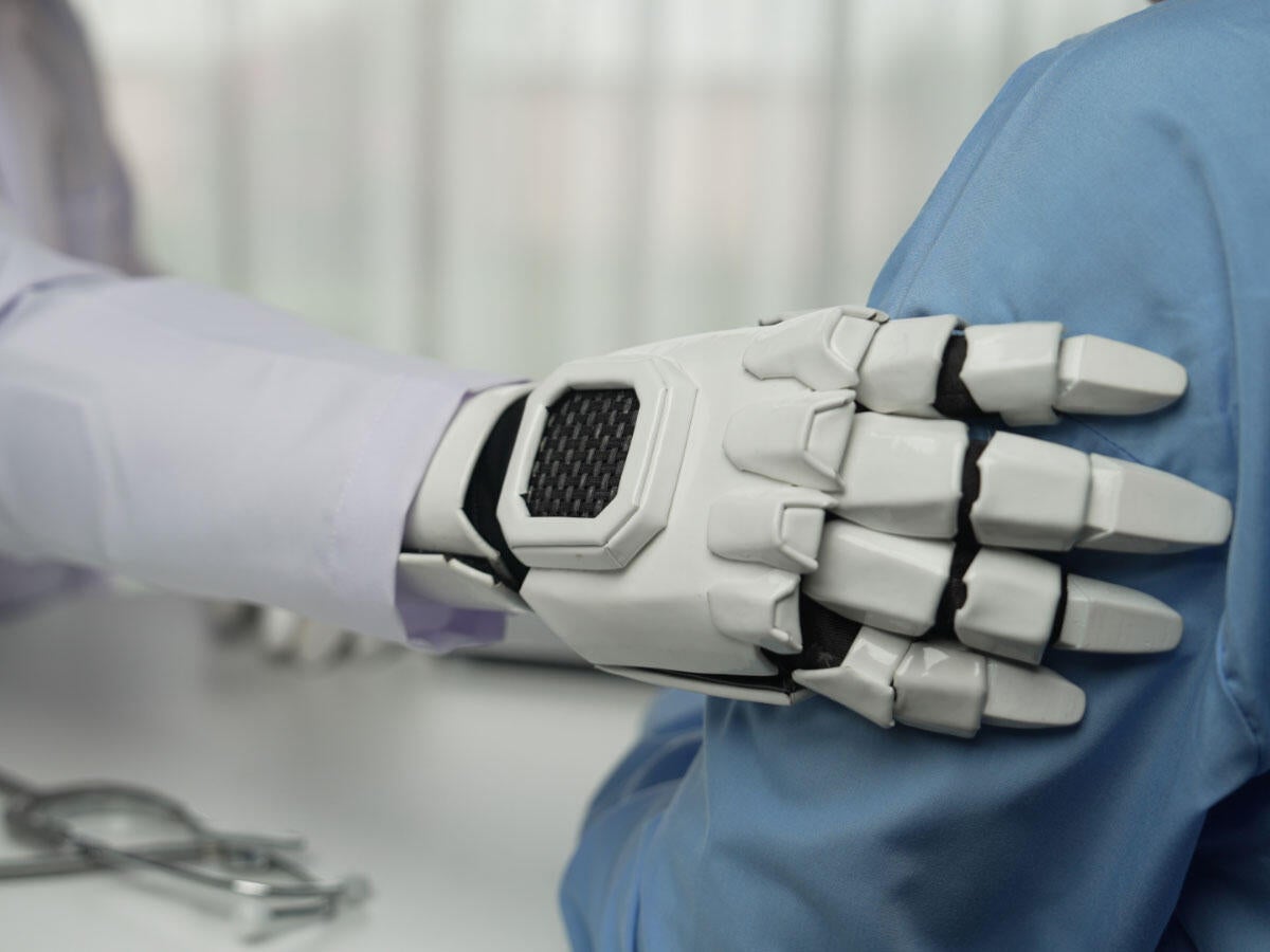 a robotic arms resting on a person's arm