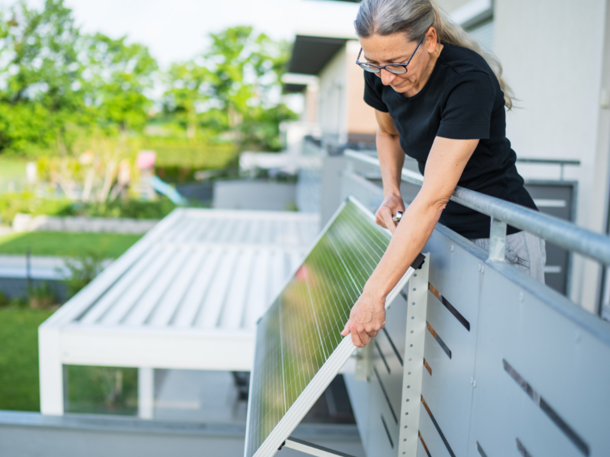Woman installs plug-in solar panel on her balcony