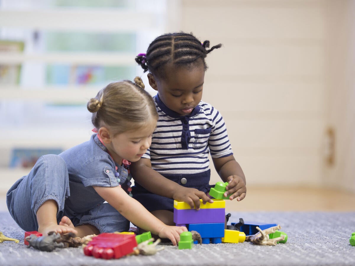 Two young children playing with toys
