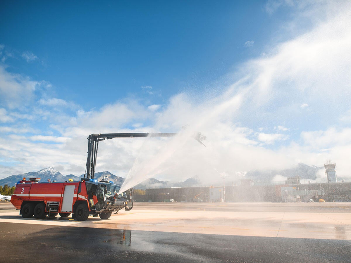 Fire truck testing it's hose by spraying it in the air