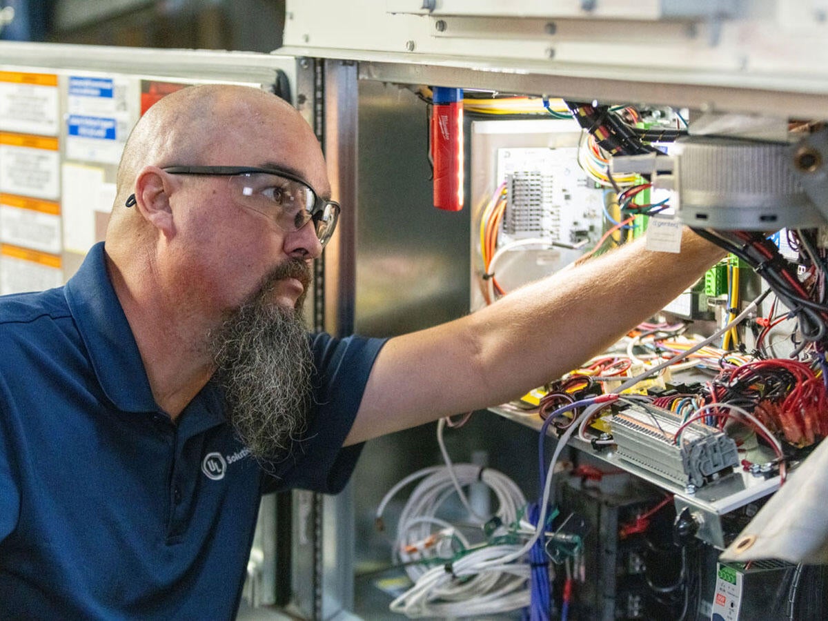 A Plano HVAC laboratory worker testing electrical