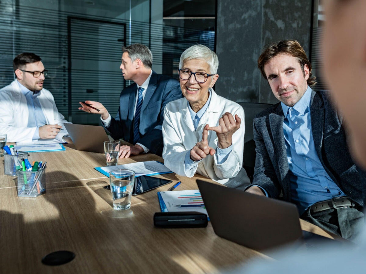 Group of medical professionals talking informally in a meeting