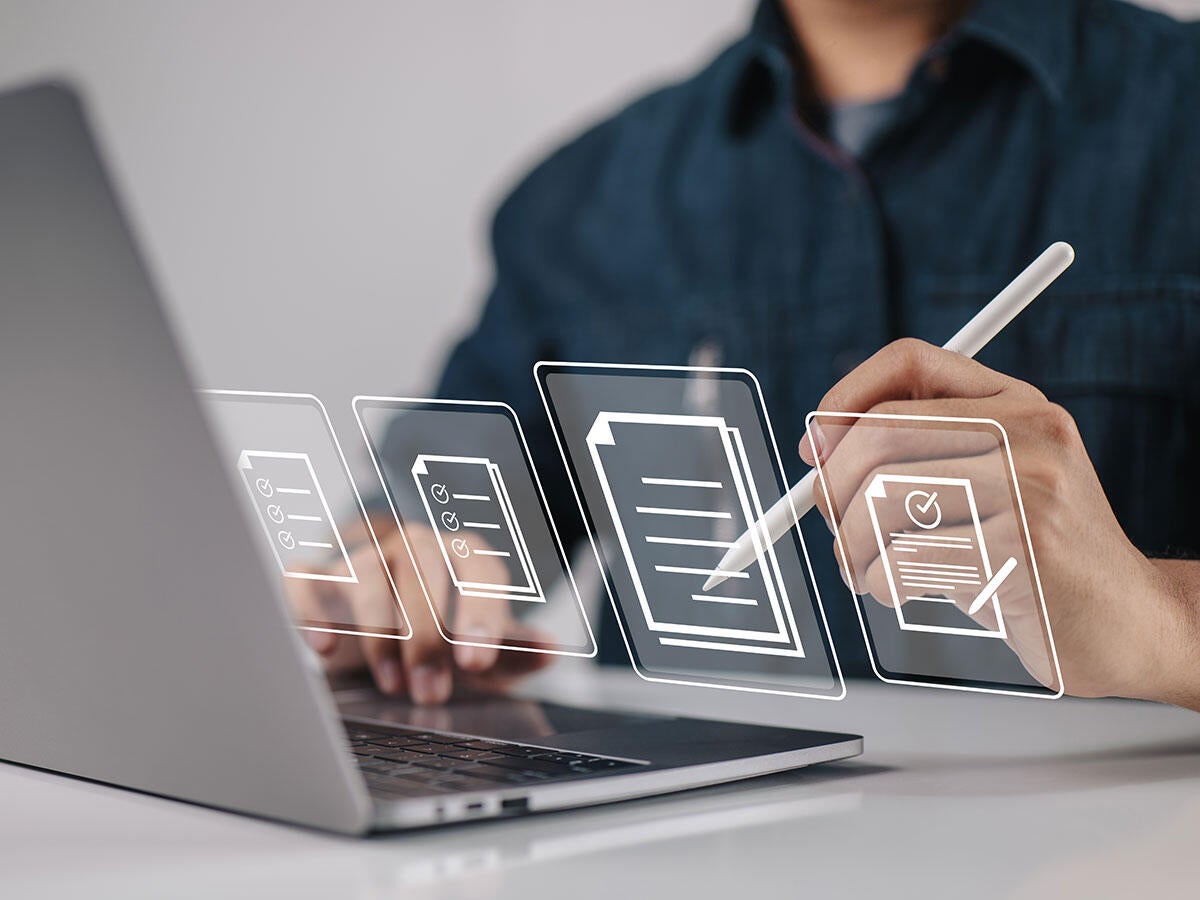 Person holding a stylus and signing an online document