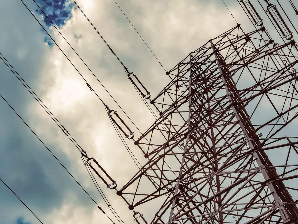 Upward view of a pylon and power lines