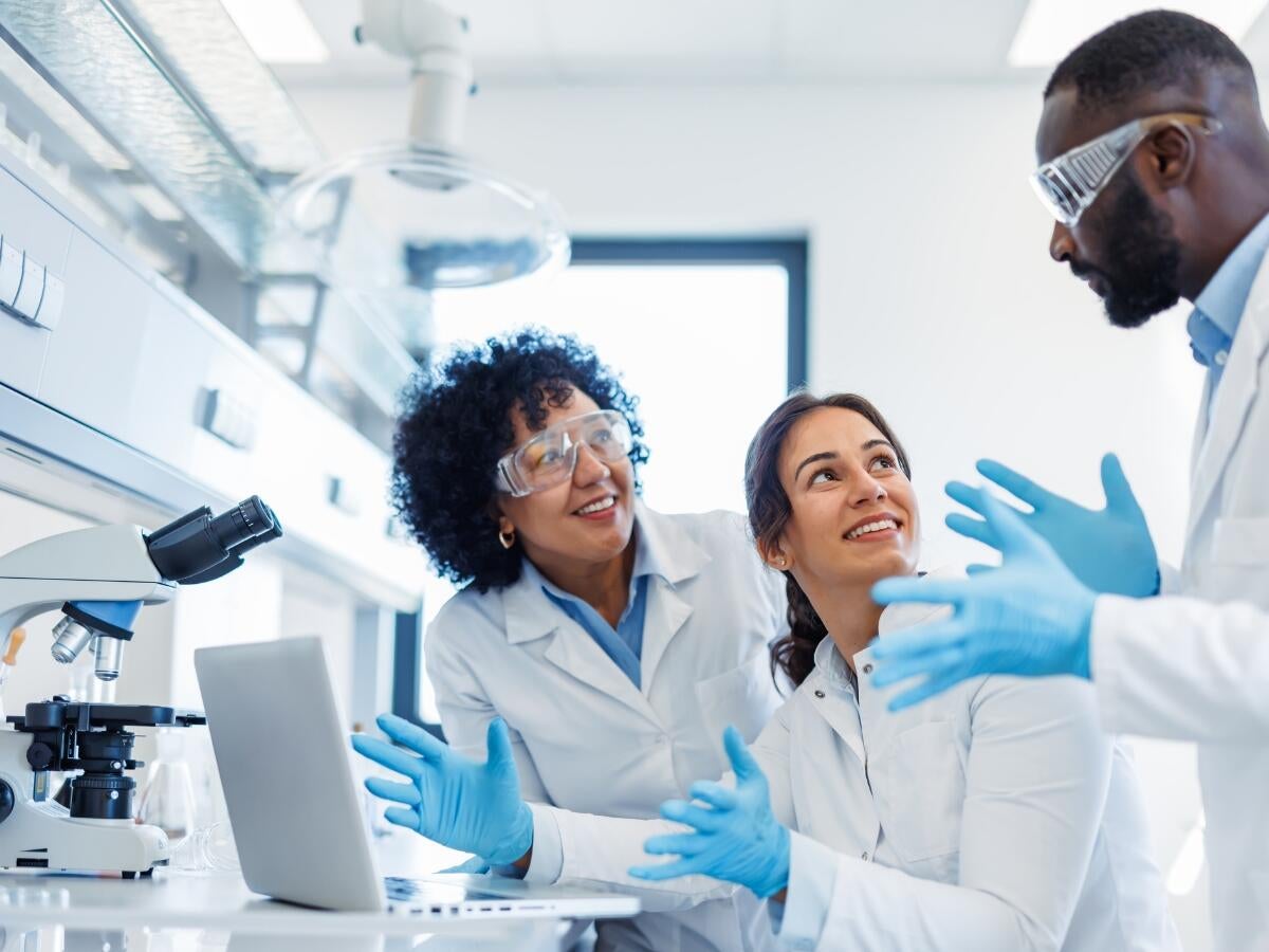 Three laboratory technicians discussing work
