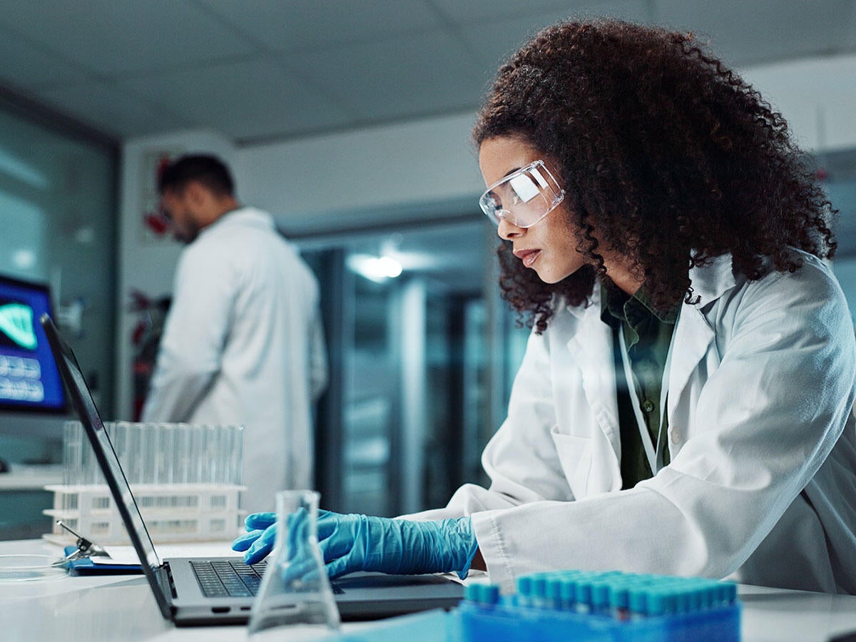 A person working on a laptop in a laboratory 