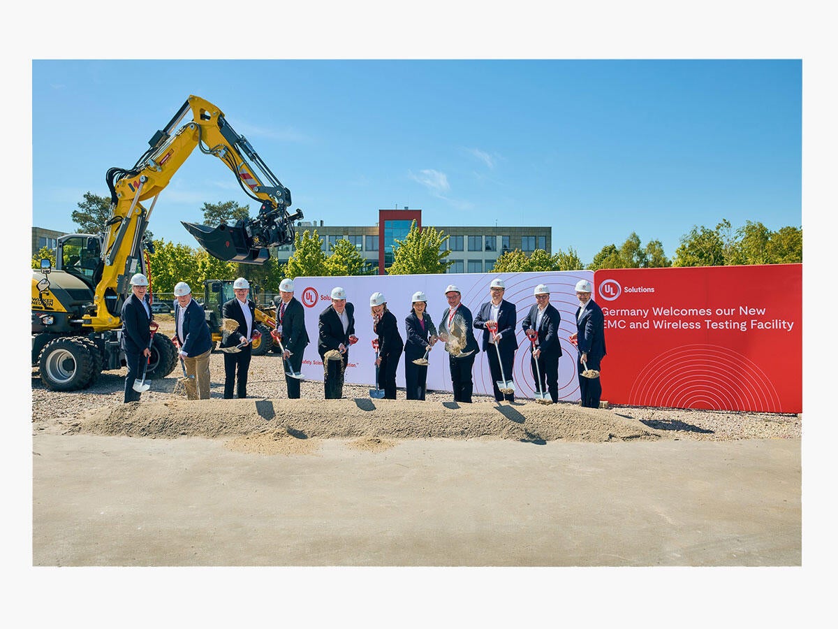 Group of people in suits and hard hats with shovels for groundbreaking