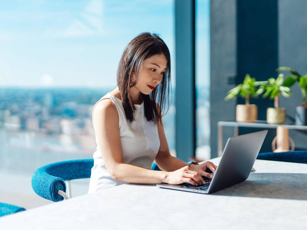 Person typing on laptop computer.