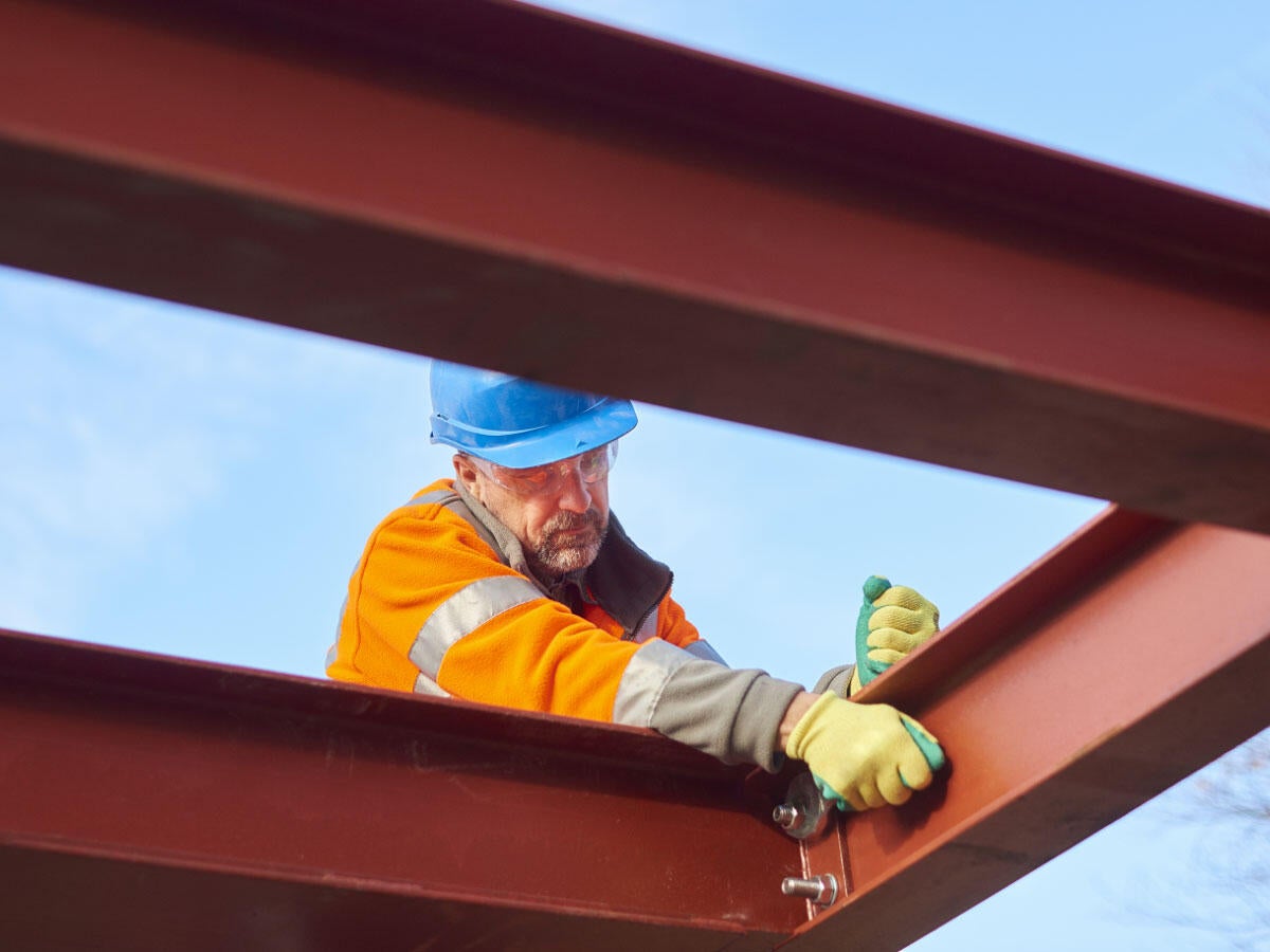 A steel worker and steel beams