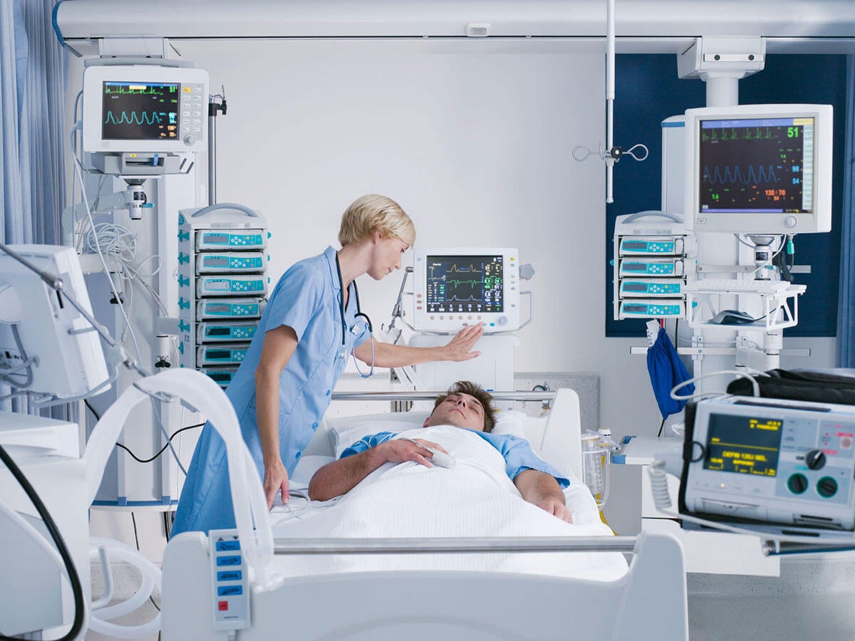 A doctor checks on a patient in a medical bed