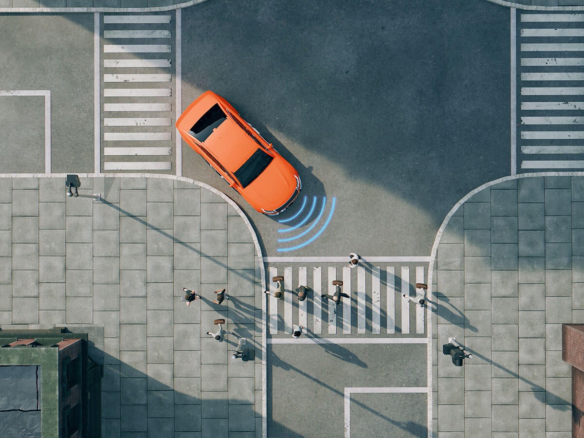 Graphic depiction of a car using autonomous driving features to stop at a busy crosswalk