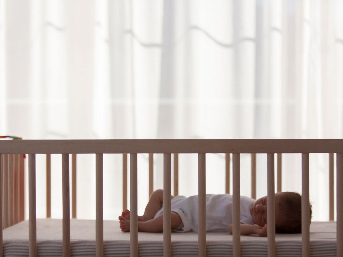 A baby sleeping in a crib