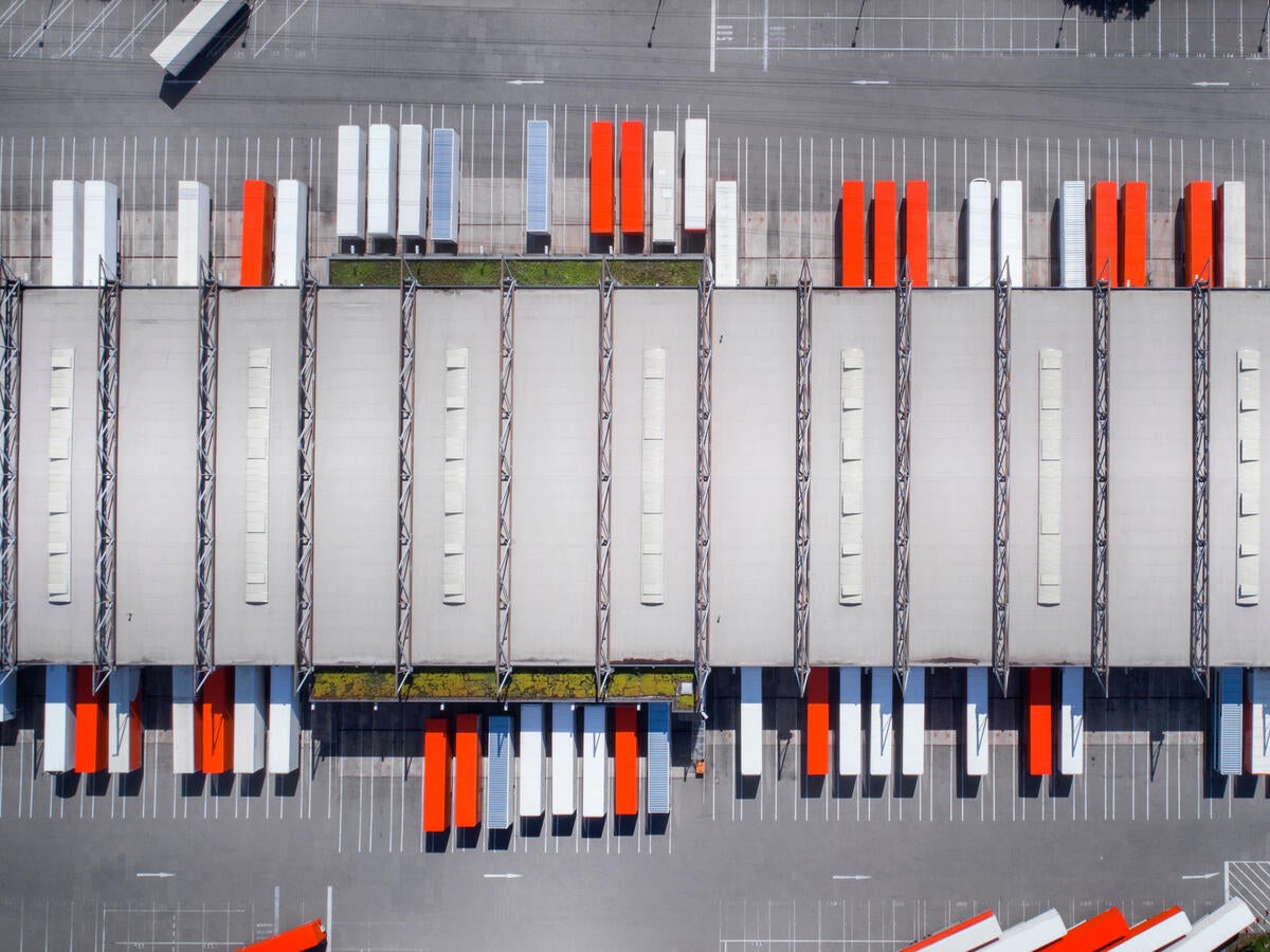 Aerial view of distribution logistics building parking lot.