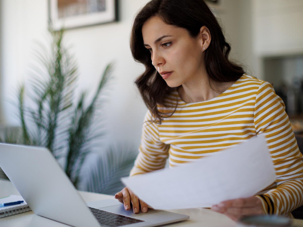 woman in striped shirt using laptop