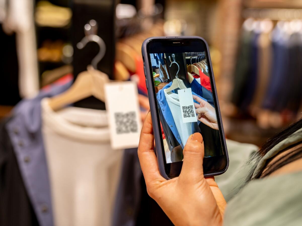 Person taking picture of a tag on a sweater