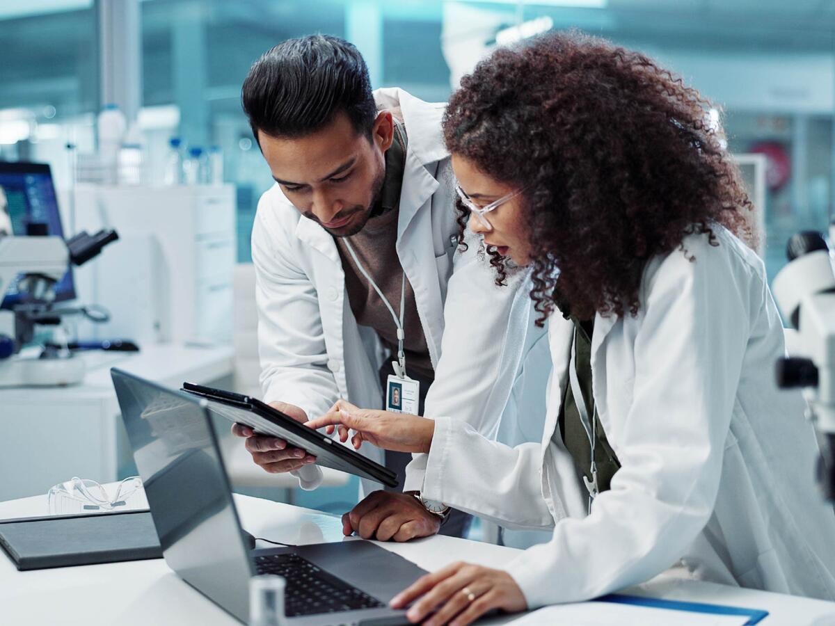 Science, teamwork and scientist with tablet in laboratory for communication, pharmaceutical review or planning. Employees, collaboration and technology for research, discussion and digital analysis